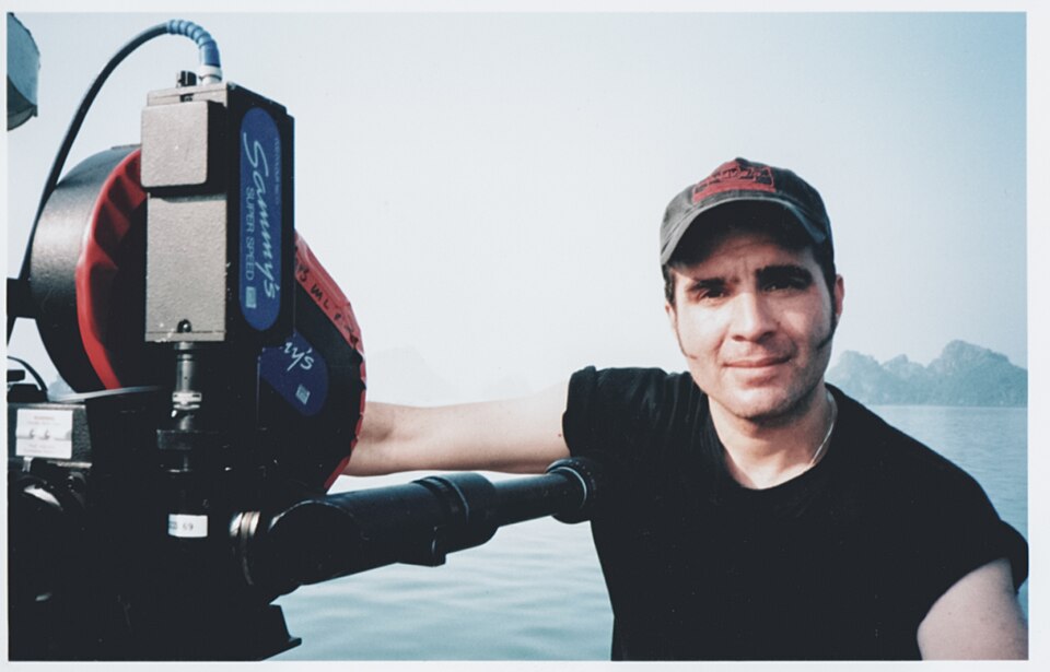 A filmmaker with a professional movie camera on location