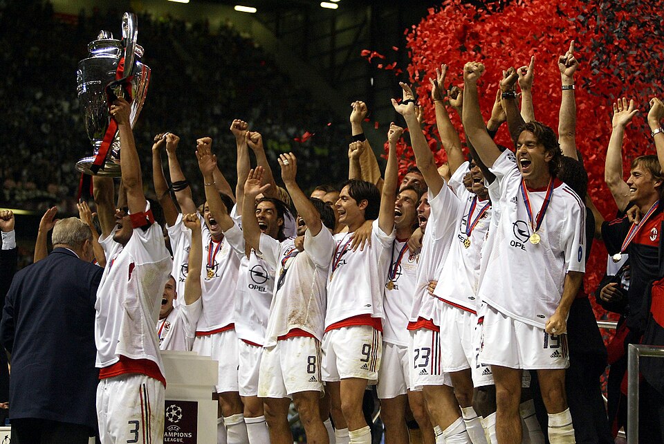 A soccer team celebrating and lifting a trophy after winning a championship