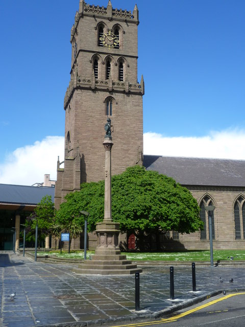 A church with a tall stone steeple tower