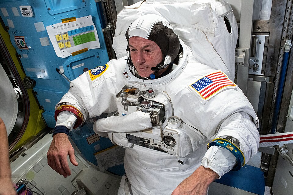 一名宇航员在太空行走之前在空间站内试穿白色宇航服